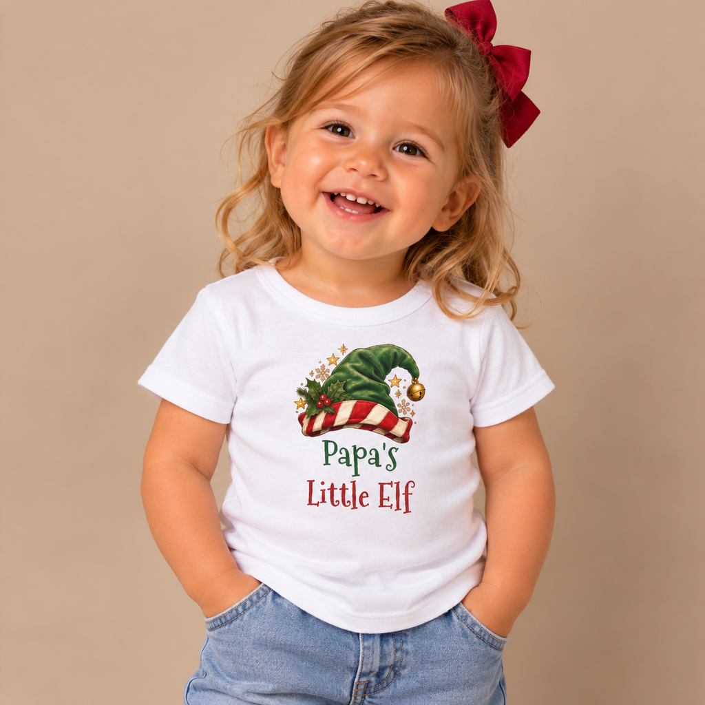 Girl wearing the White Papa's Little Elf Baby T-Shirt