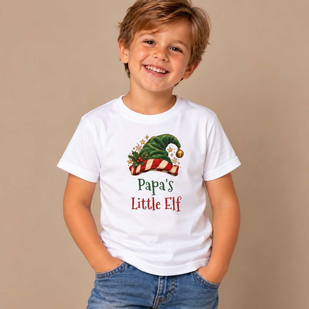 Boy wearing the White Papa's Little Elf Kids T-Shirt