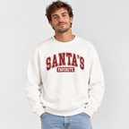 Man wearing the White Santa's Favorite Varsity Christmas Sweatshirt with jeans