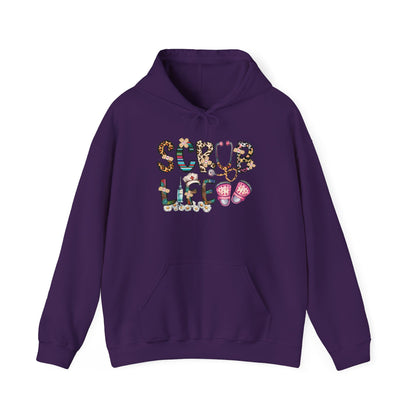 Purple Scrub Life nurse hoodie with patterned lettering, stethoscope and clogs