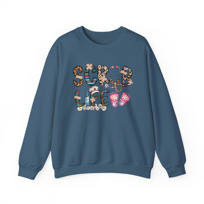 Indigo blue Scrub Life nurse sweatshirt with patterned lettering, stethoscope and clogs