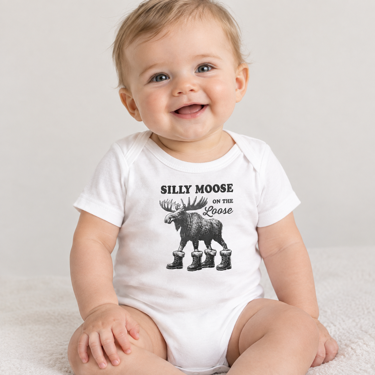 Baby wearing the Silly Moose On The Loose vintage moose baby bodysuit