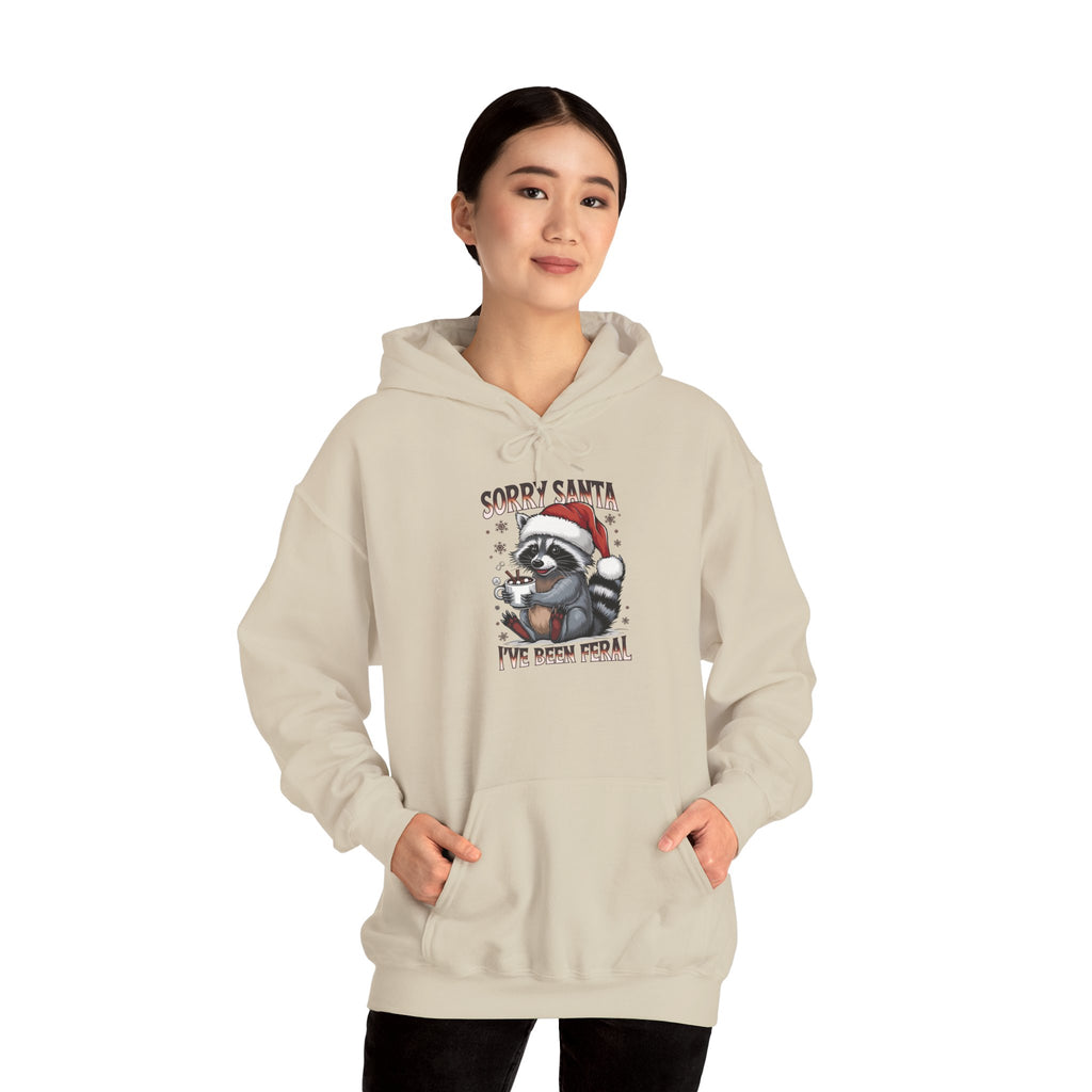 Woman wearing the Sand Sorry Santa I've Been Feral Raccoon Hoodie