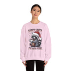 Woman wearing the Light Pink Sorry Santa I've Been Feral Raccoon Sweatshirt