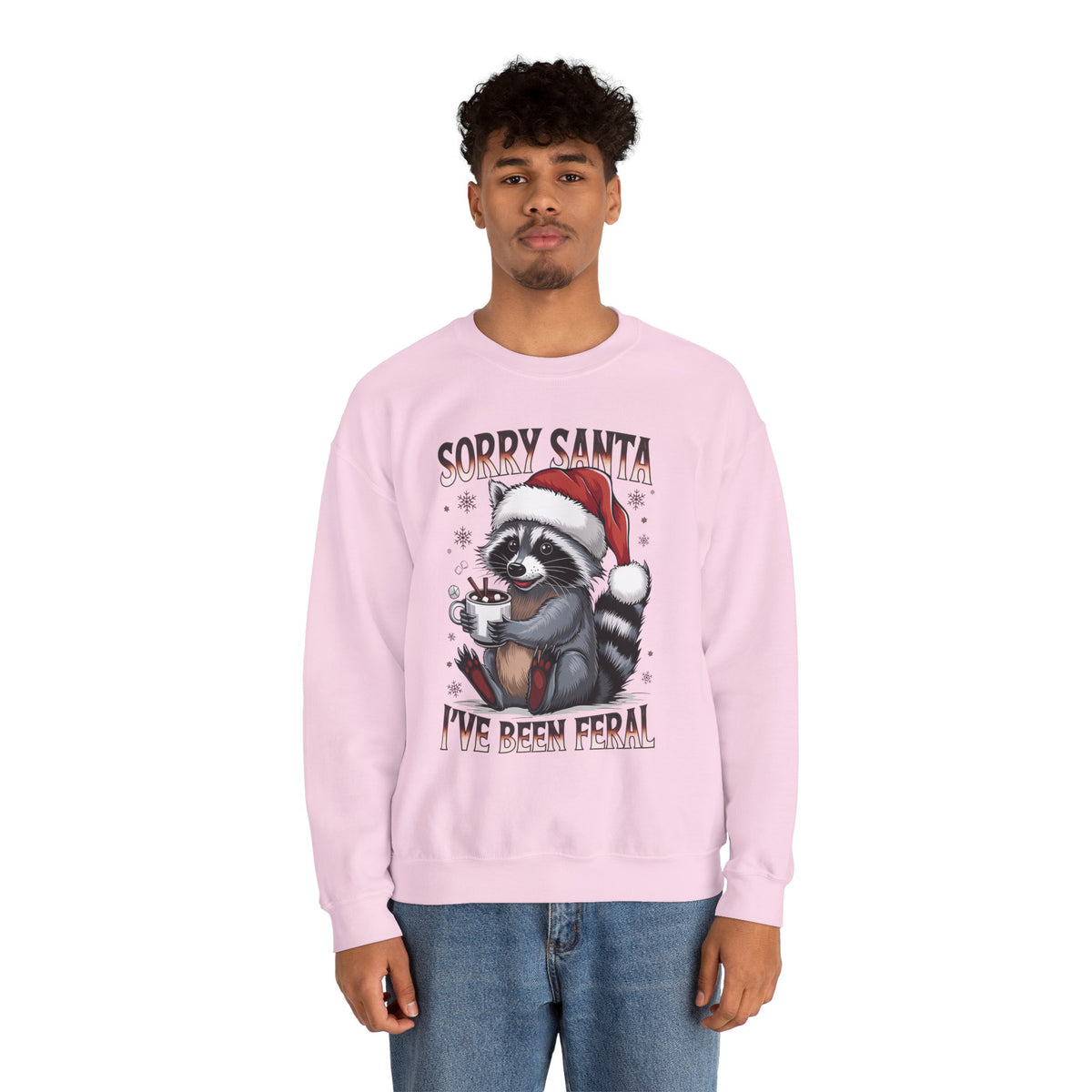 Man wearing the Light Pink Sorry Santa I've Been Feral Raccoon Sweatshirt