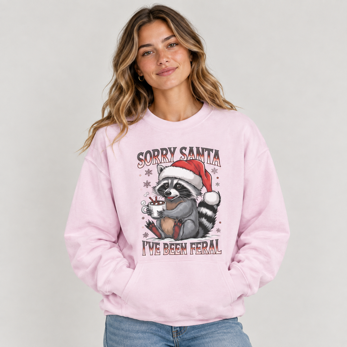 Woman wearing the Light Pink Sorry Santa I've Been Feral Raccoon Sweatshirt with jeans