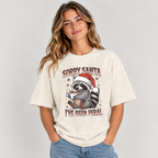 Woman wearing the Natural Sorry Santa I've Been Feral Raccoon T-Shirt with jeans