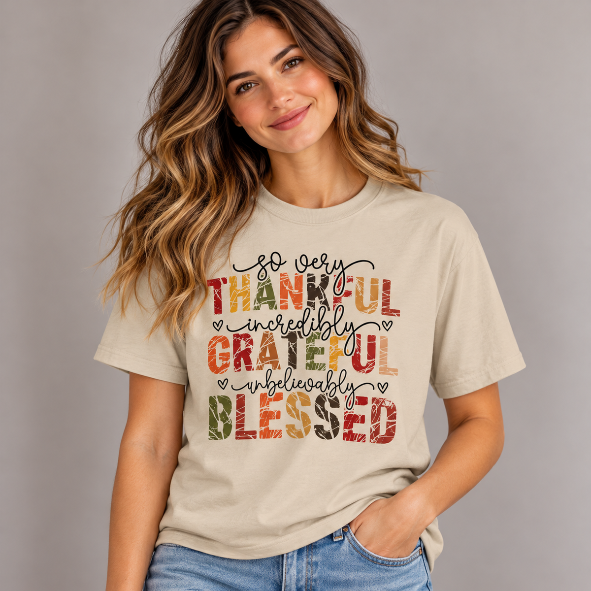 Woman wearing the Sand Thankful Grateful Blessed T-Shirt with jeans