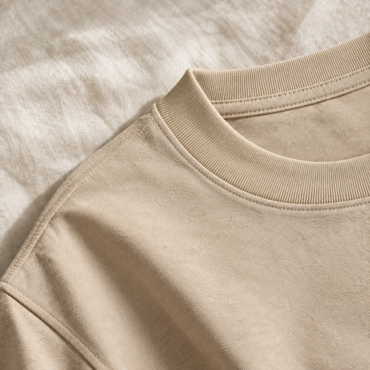 Close-up of a heavyweight cotton t-shirt collar in sand